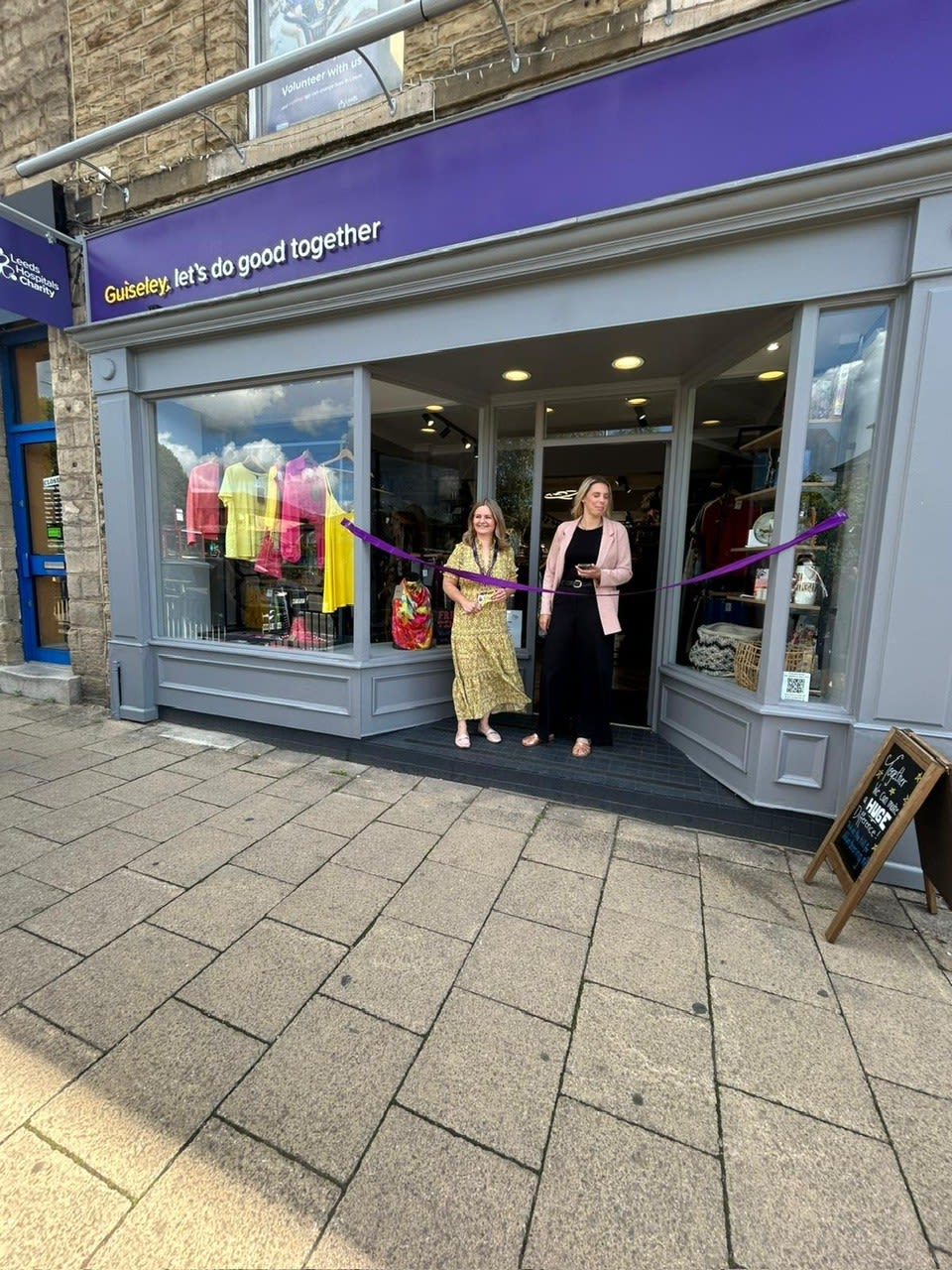 Esther Wakeman, CEO and Lauren Glaister, Trustee cutting the ribbon of the new shop